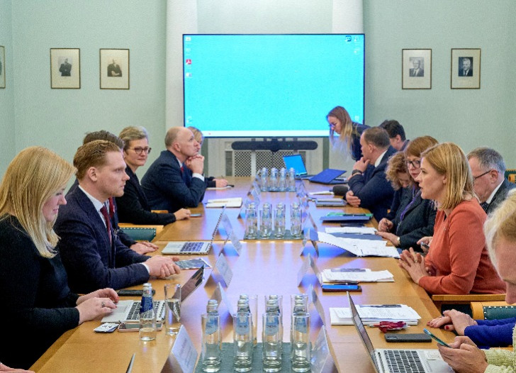 People sit around the table and the Head of Financial Intelligence Unit of Latvia presents the National Risk Assessment for Money Laundering and Terrorism and Proliferation Financing covering the 2020-2022 period to the Financial Sector Development Board